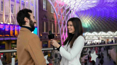 medium-shot-smiley-reporter-outdoors_11zon